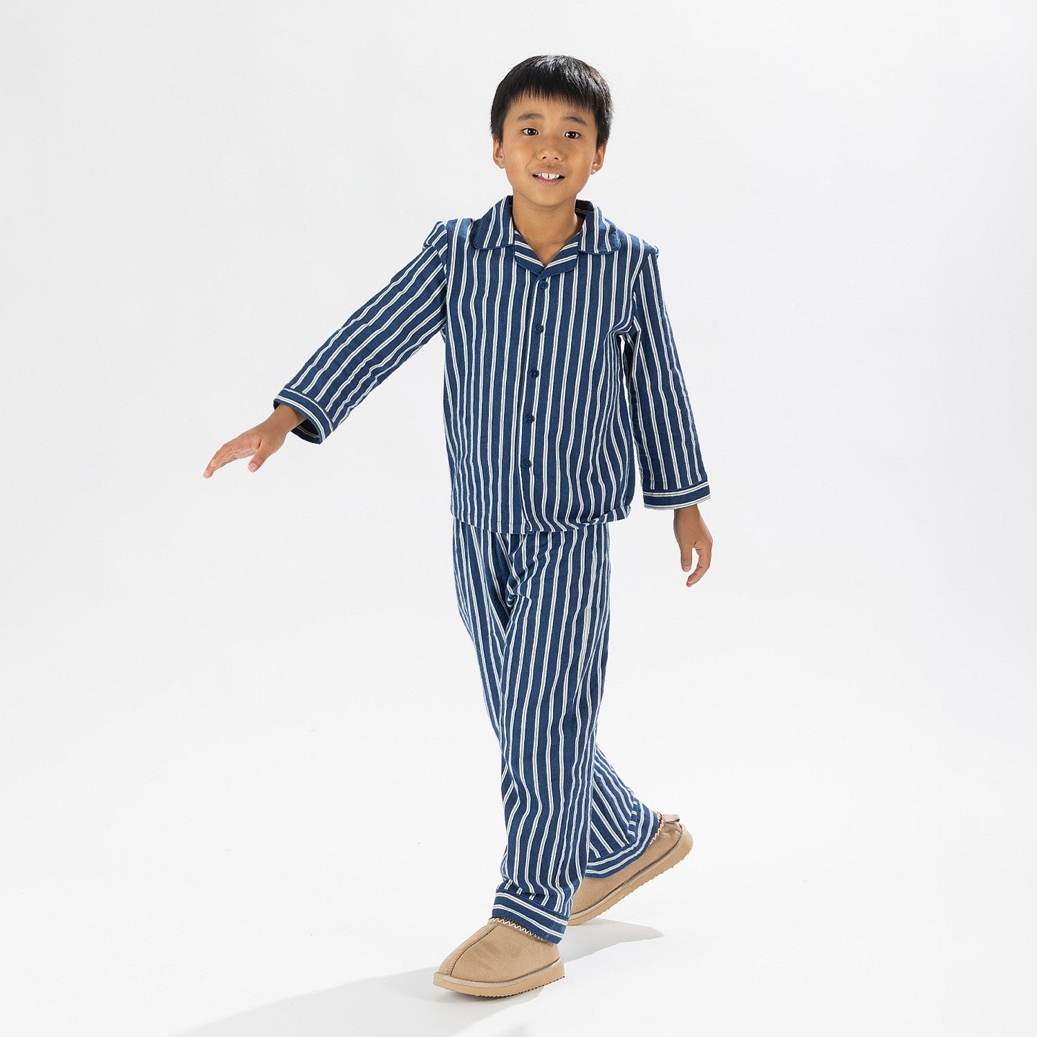 Child wearing blue striped flannelette pyjamas