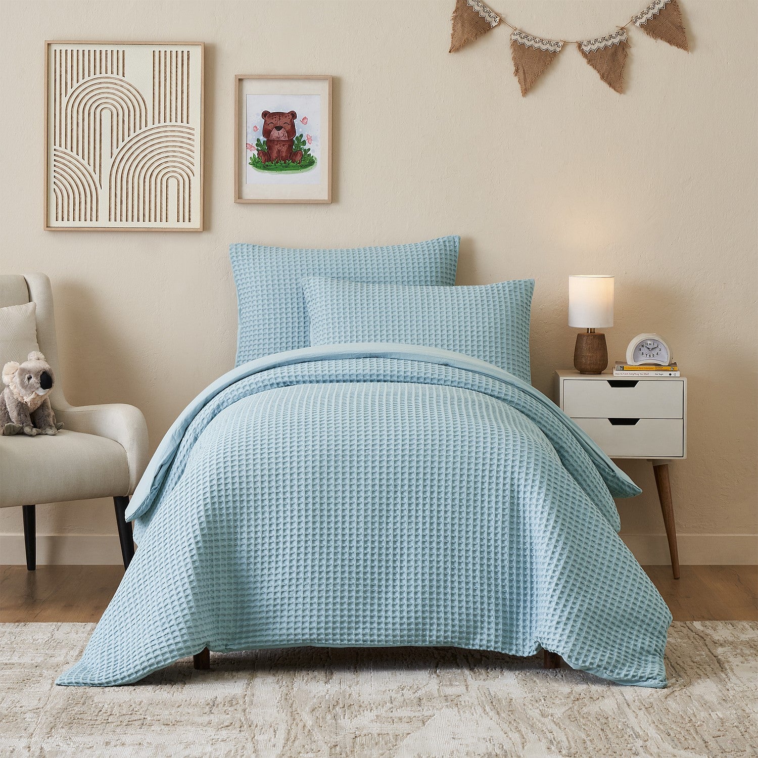 Light blue duvet cover set styled on a bed in a neutral bedroom.