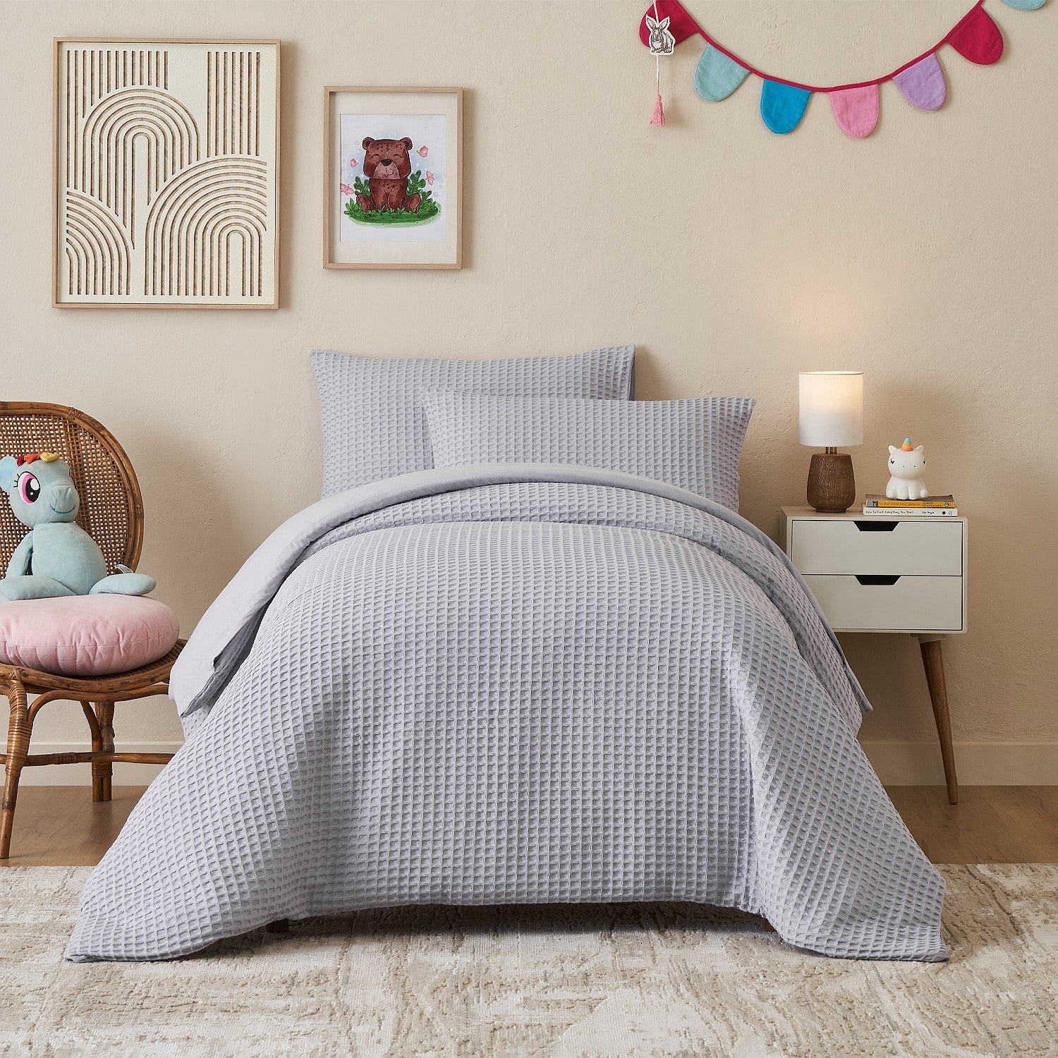 Light purple duvet cover set styled on a bed in a neutral bedroom.