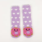 Purple kids bed socks with pink donuts with face design, in a white background.