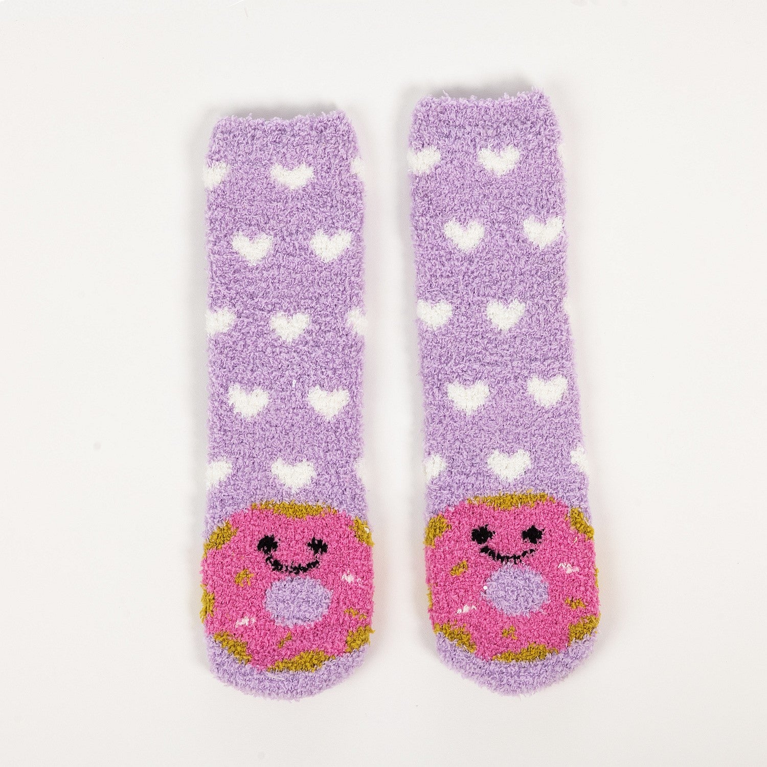 Purple kids bed socks with pink donuts with face design, in a white background.