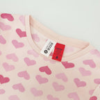 pink heart print pyjamas with the red warning label and tag