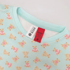 light green teddy printed pyjamas close up with the tag and warning label showing 