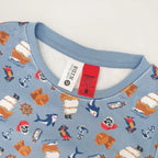 close up of blue pirate printed pyjamas showing the warning label and tag.