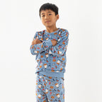 Child wearing blue pirate printed pyjamas standing
