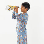 Child wearing blue pirate printed pyjamas standing