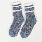 Blue sherpa lined slipper socks with striped cuff detail in a white background 