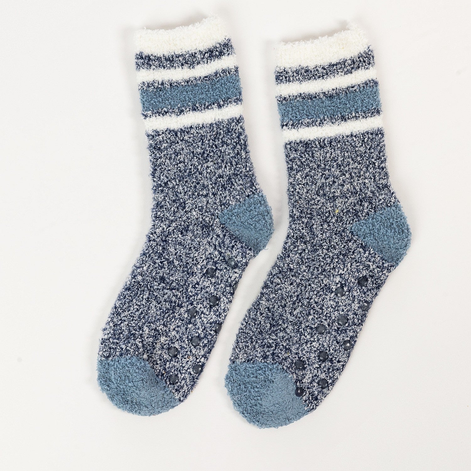 Blue sherpa lined slipper socks with striped cuff detail in a white background 