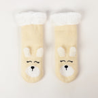 Cream puppy slipper socks with soft fleece lining on a white background