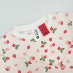 pink and red heart print pyjamas with the tag and warning label showing.