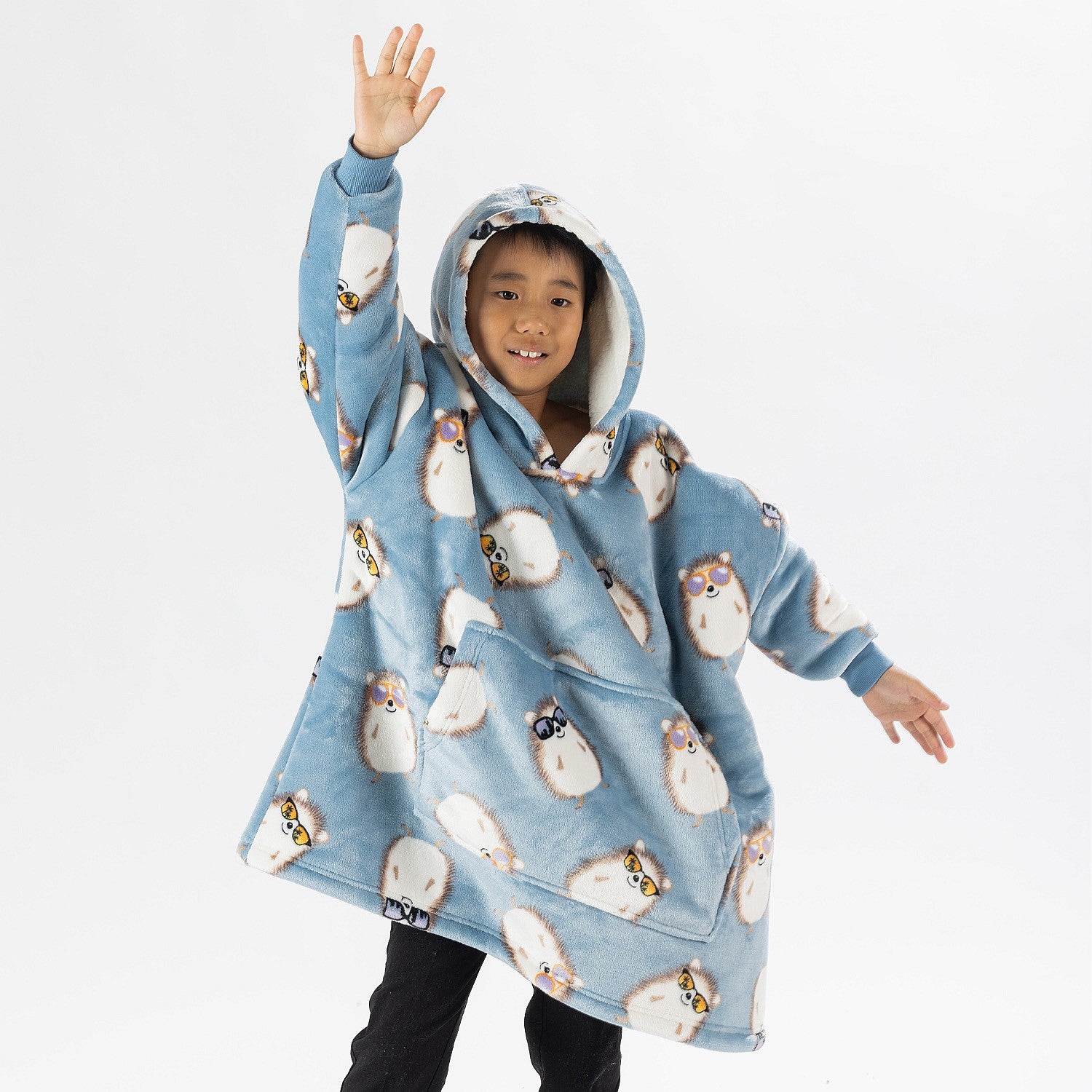 Child wearing a blue hedgehog print oversized hoodie with a cosy hood and front pocket.