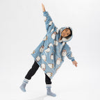Child wearing a blue hedgehog print oversized hoodie with a cosy hood and front pocket.