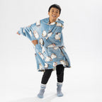 Child wearing a blue hedgehog print oversized hoodie with a cosy hood and front pocket.