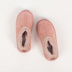 Pink faux fur slippers with soft lining on a white background