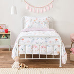 Kids butterfly print cot cover set styled on a white framed bed in a soft neutral room.