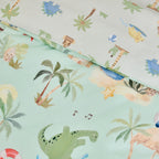 Close-up of the bb&b Kids Dino Beach Party duvet cover set showing the mint green dinosaur print alongside the coordinating lighter pillowcase design with dinosaurs and beach motifs.