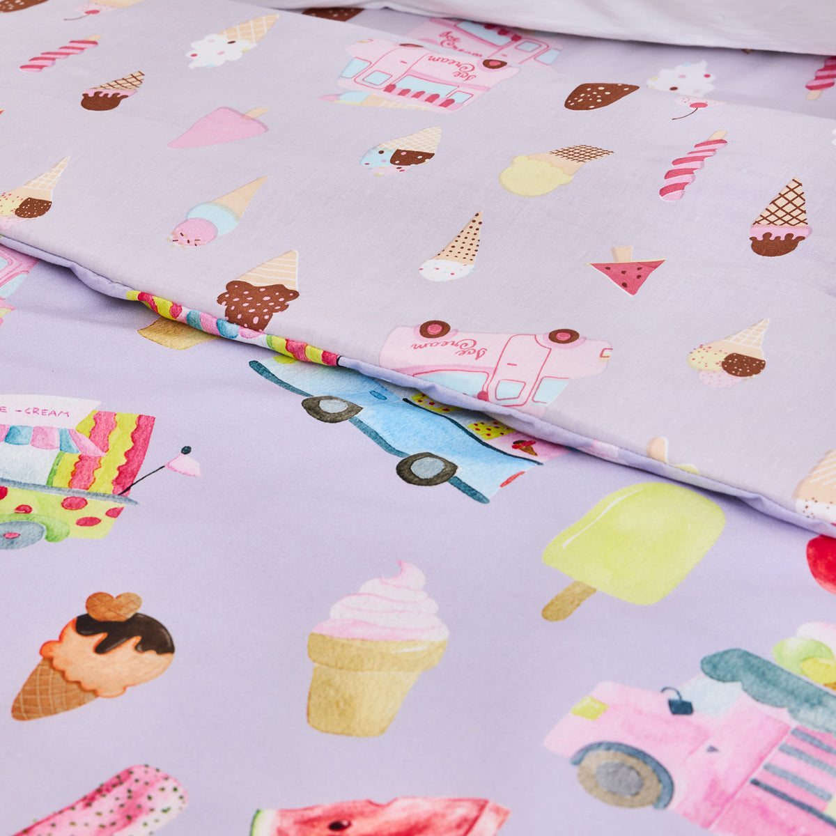Close-up of the bb&b Kids Ice Cream Shop duvet cover set showing the lilac bedding print with colourful ice cream cones, popsicles, trucks and sweet treat motifs.
