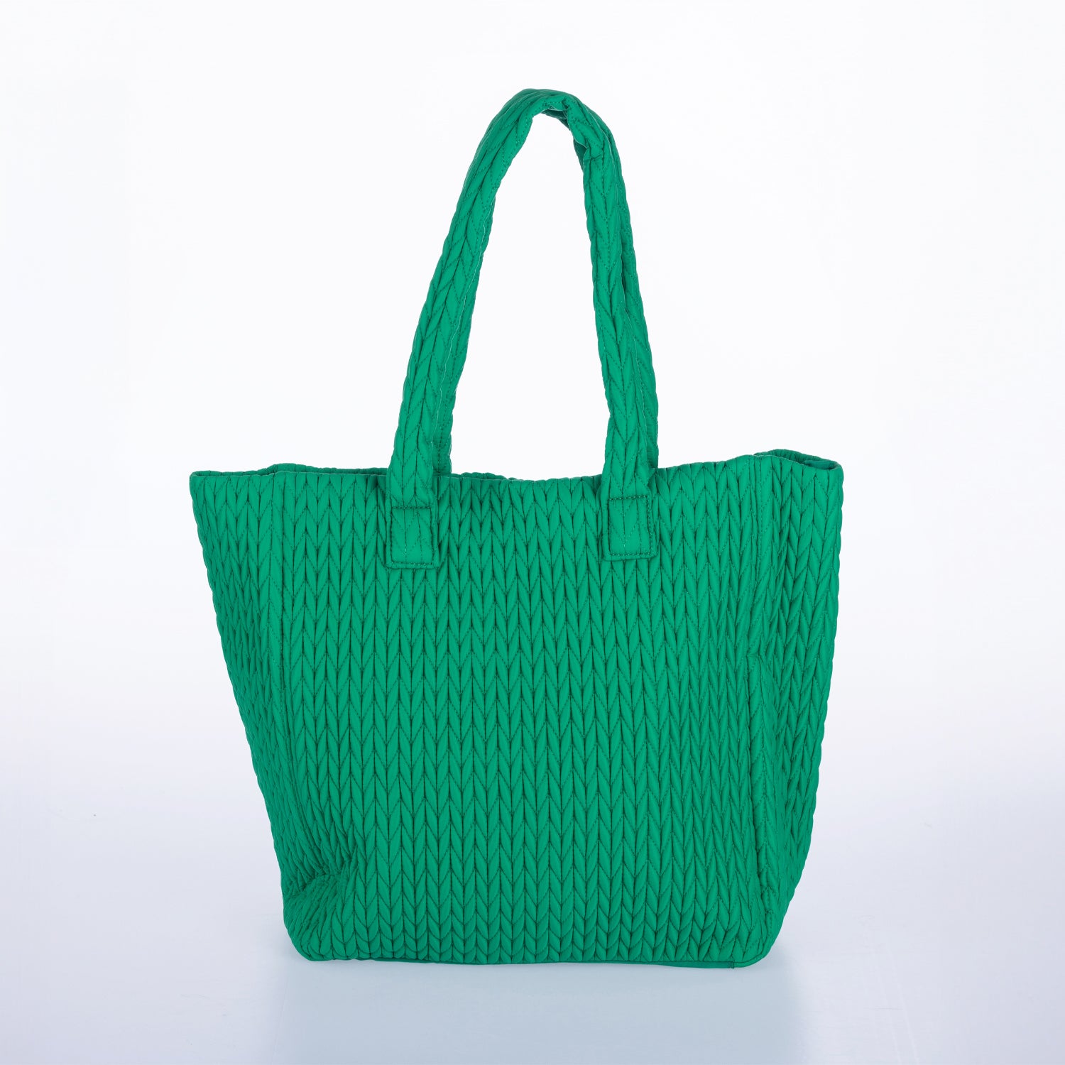 Green woven tote bag with double shoulder straps and textured knitted design on a white background.