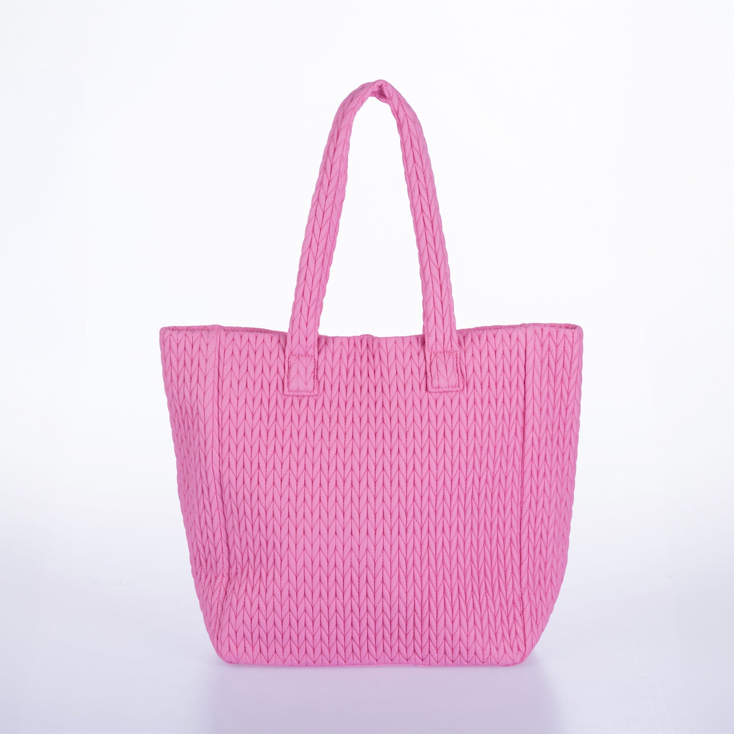 Pink woven tote bag with double shoulder straps and textured knitted design on a white background.