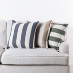Home Co. Ashley Cushions in Navy, Natural and Olive styled together on a neutral sofa.