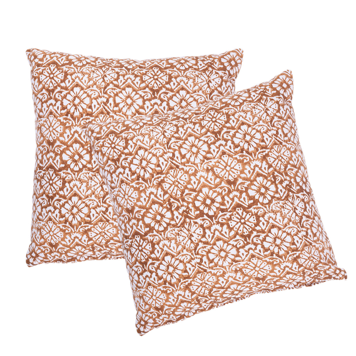 Two square decorative throw pillows with a white floral and geometric block-print pattern on a warm terracotta brown background, shown against a plain white studio background.