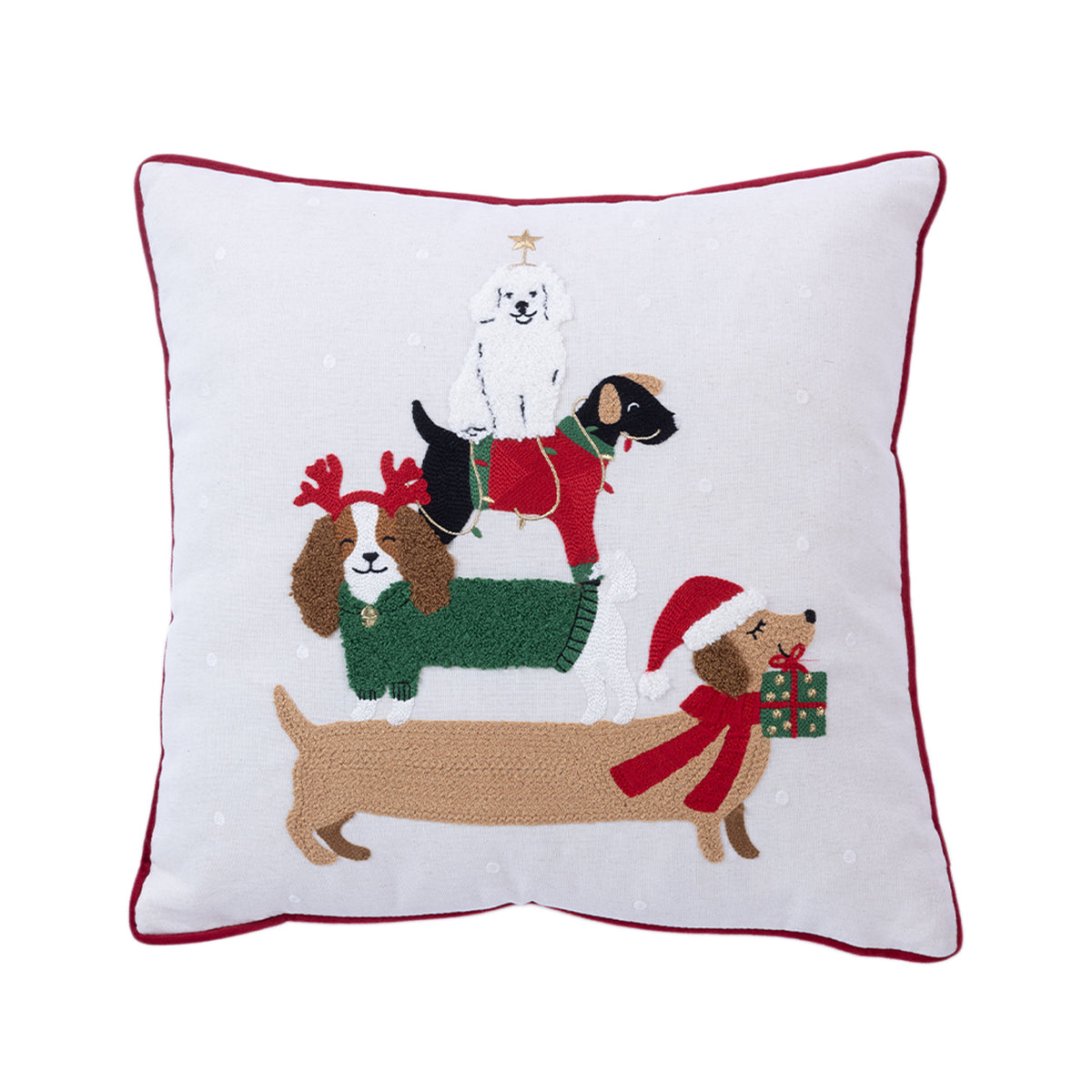 Front view of a white Christmas cushion featuring four embroidered festive dogs in Christmas outfits, finished with red piping.