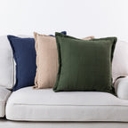 Home Co. Bailey Cushions in Navy, Natural and Olive styled together on a neutral sofa.