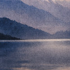 Close-up of the Fieldcrest Fiordland at Dusk Cushion showing the woven fabric texture and layered blue mountain and lake design.