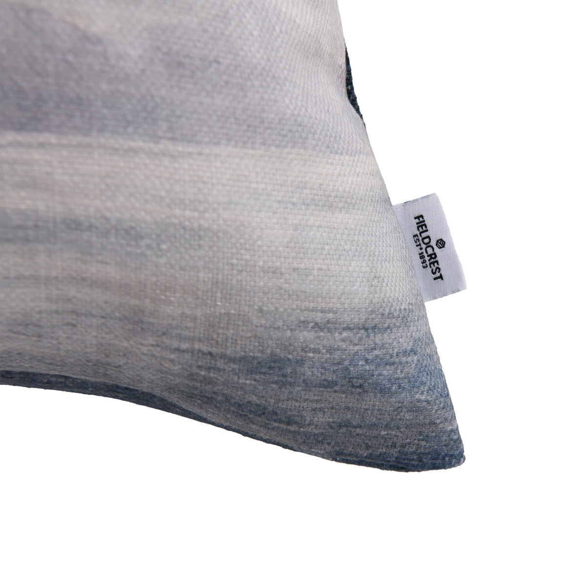 Close-up of the Fieldcrest Aoraki Mount Cook Cushion corner showing the textured fabric, soft mountain print and Fieldcrest brand label.