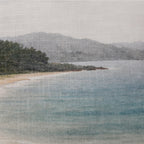 Close-up of the Fieldcrest Serene Coast Cushion showing the woven fabric texture, pale blue water, sandy shoreline and distant hills.