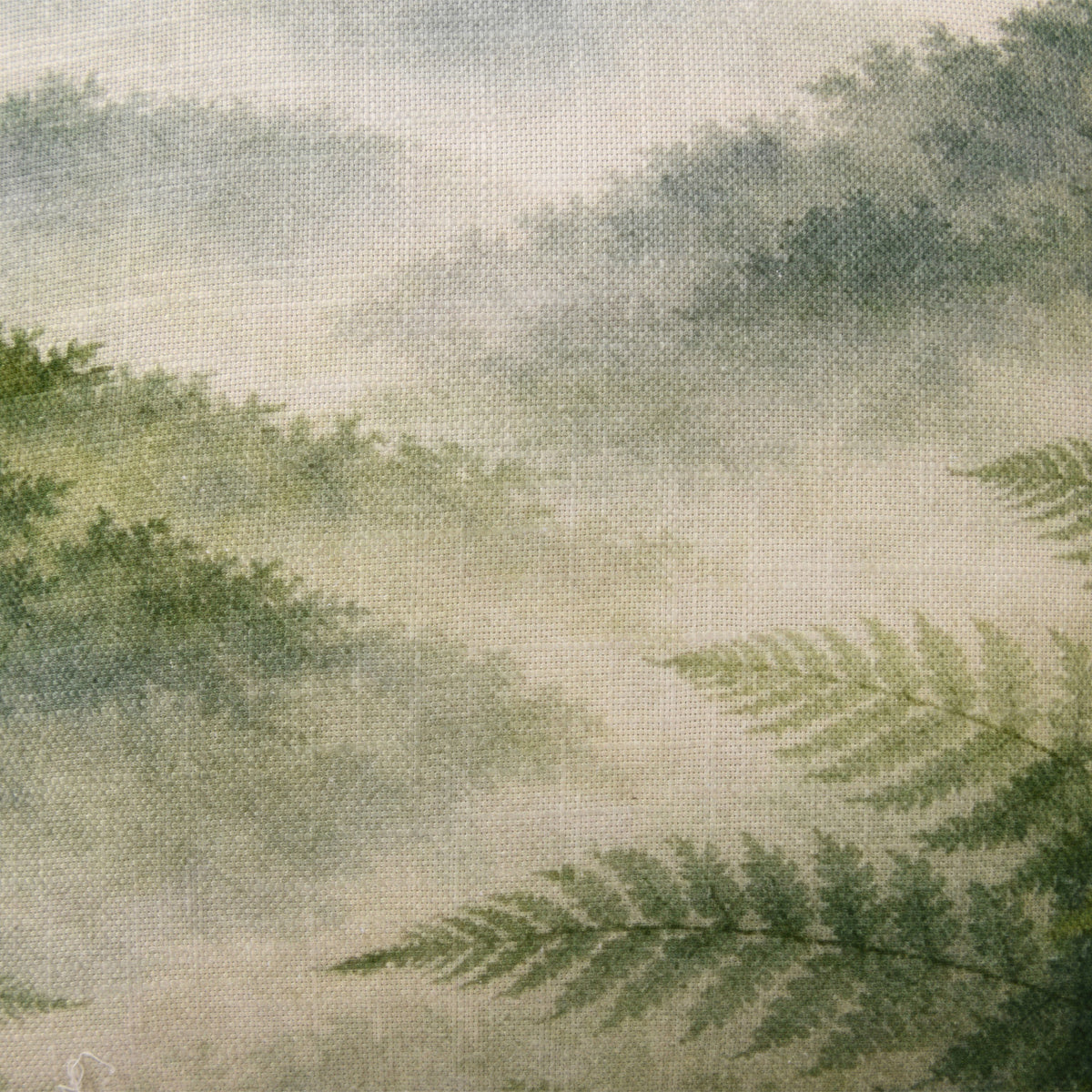 Close-up of the Fieldcrest Northland Forest Cushion showing the woven fabric texture, misty forest scenery and layered green fern details.