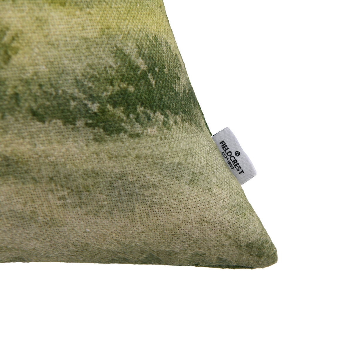 Close-up of the Fieldcrest Whanganui Grazing Cushion corner showing the textured fabric, green landscape print and Fieldcrest brand label.