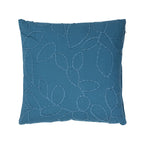 Denim blue square cushion featuring a raised embroidered leaf pattern across the front.