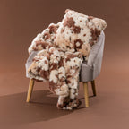 Amparo Macey Cushion in blush styled with the coordinating throw on a grey chair.