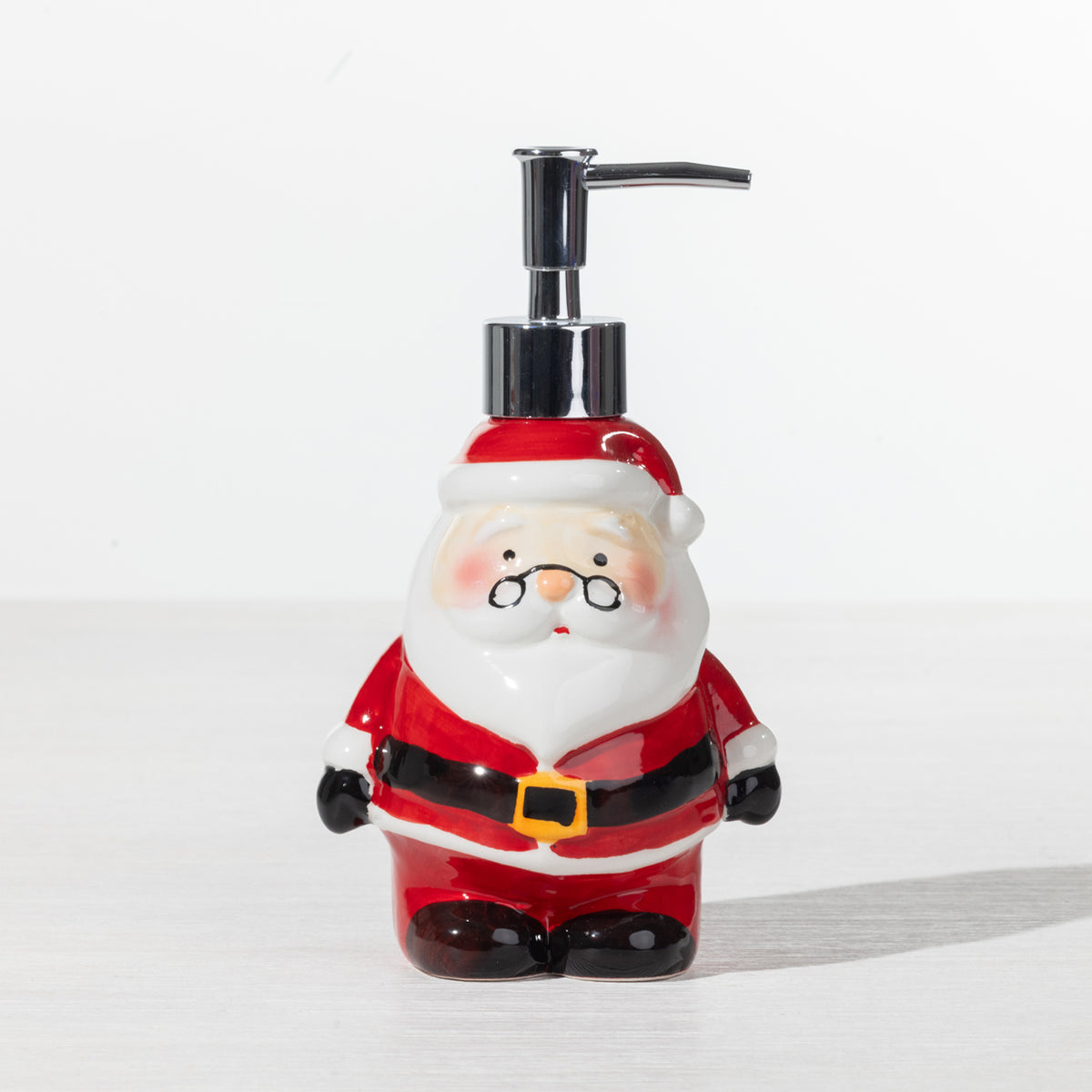 Christmas Wishes Santa soap dispenser with red suit, white beard and silver pump on a white background.