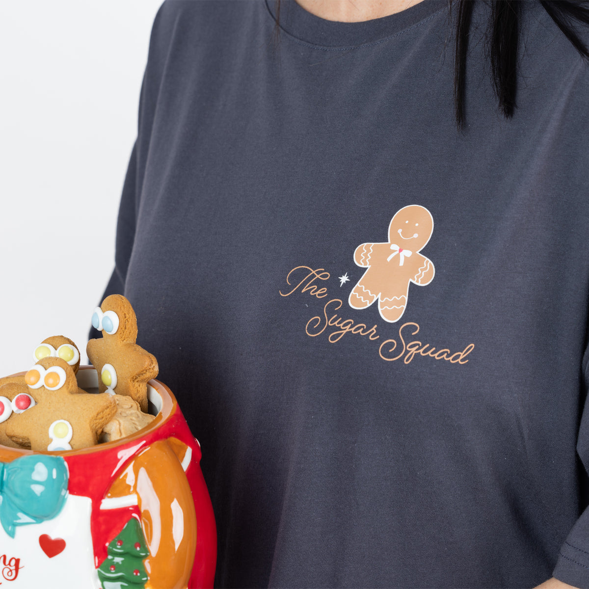 Close-up of the Christmas Wishes Christmas Sugar Squad Sleep Tee in charcoal showing the gingerbread character and The Sugar Squad chest print.