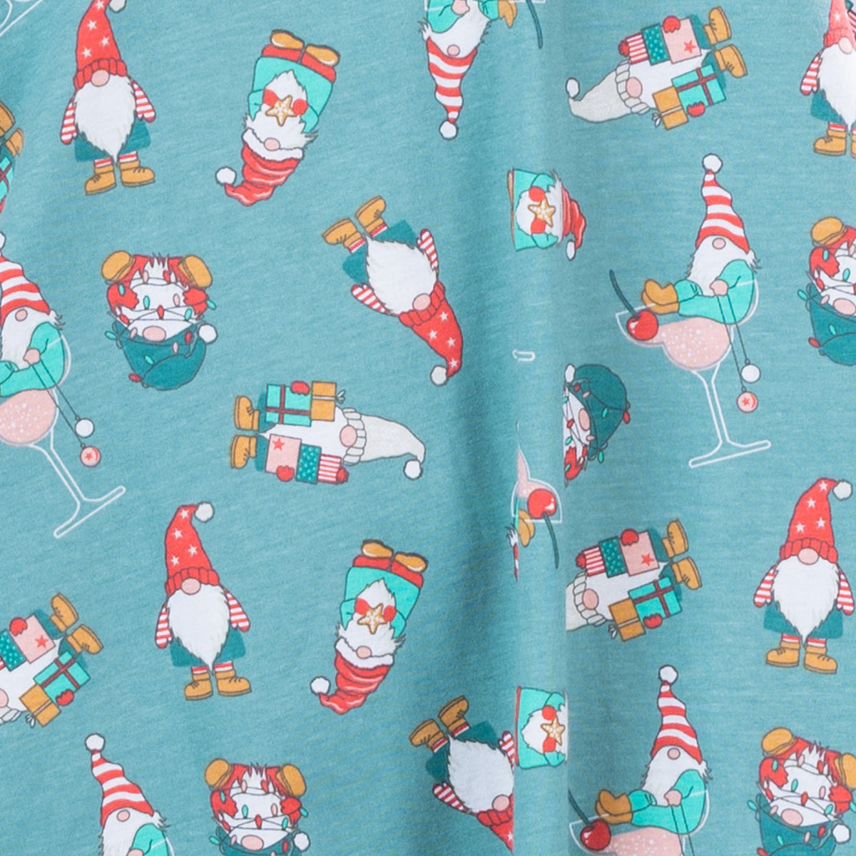 Close-up of the jade Christmas Gnome Sleep Tee fabric featuring colourful festive gnomes, gifts and Christmas-themed illustrations.