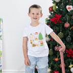 Boy wearing the Christmas Wishes Cheer Kids Tee in white, showing the colourful Santa, Christmas tree, gifts and festive character print.