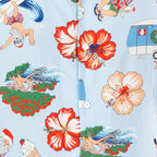 Close-up of the faded blue festive shirt print featuring Santa, hibiscus flowers, beach scenes, caravans and summer Christmas motifs.