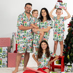 Family wearing matching Christmas Wishes Tui PJ Sets in white in a festive Christmas setting.