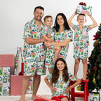 Family wearing matching Christmas Wishes Tui PJ Sets in white in a festive Christmas setting.