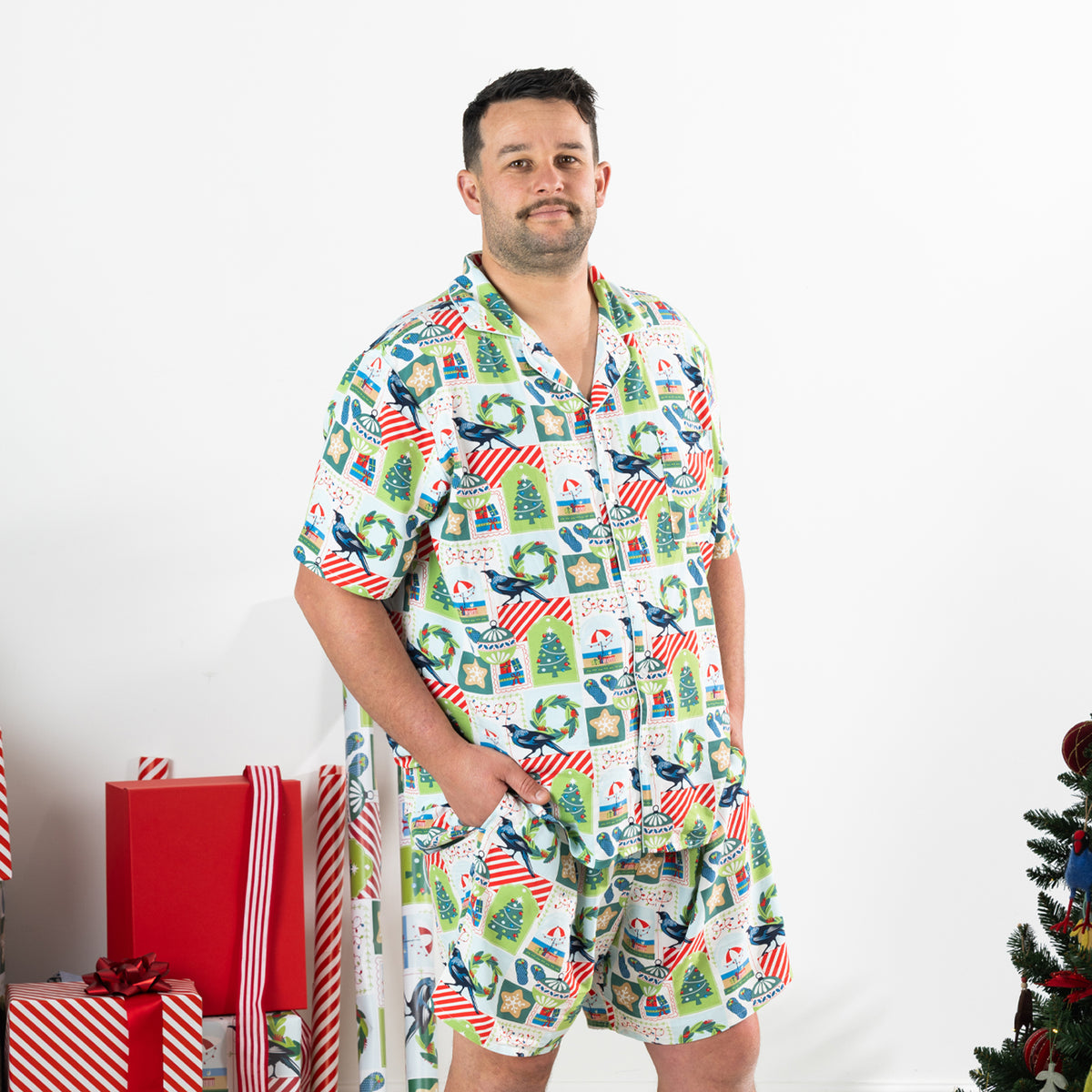 Man modelling the Christmas Wishes Tui Men’s PJ Set in white from a three-quarter angle.