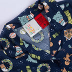 Close-up of the Christmas Wishes Wreath Kids PJ Set collar, festive print, size label and safety warning tag.