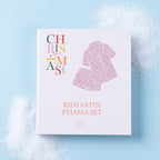 Christmas Wishes Kids’ Satin Bow PJ Gift Set packaging displayed on a light blue background.