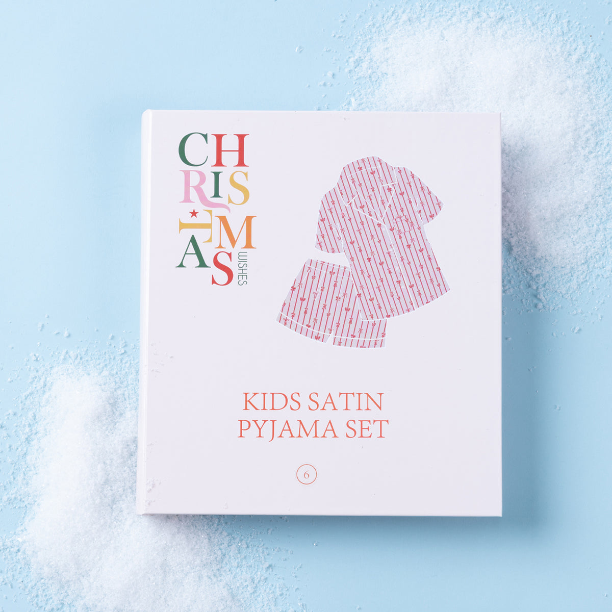 Christmas Wishes Kids’ Satin Bow PJ Gift Set packaging displayed on a light blue background.