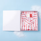 Christmas Wishes Kids’ Satin Bow PJ Gift Set folded inside an open gift box on a light blue background.