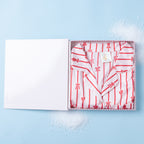 Christmas Wishes Women’s Satin Bow PJ Gift Set folded inside an open gift box on a light blue background.