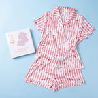 Christmas Wishes Women’s Satin Bow PJ Set displayed with matching gift box on a light blue background.