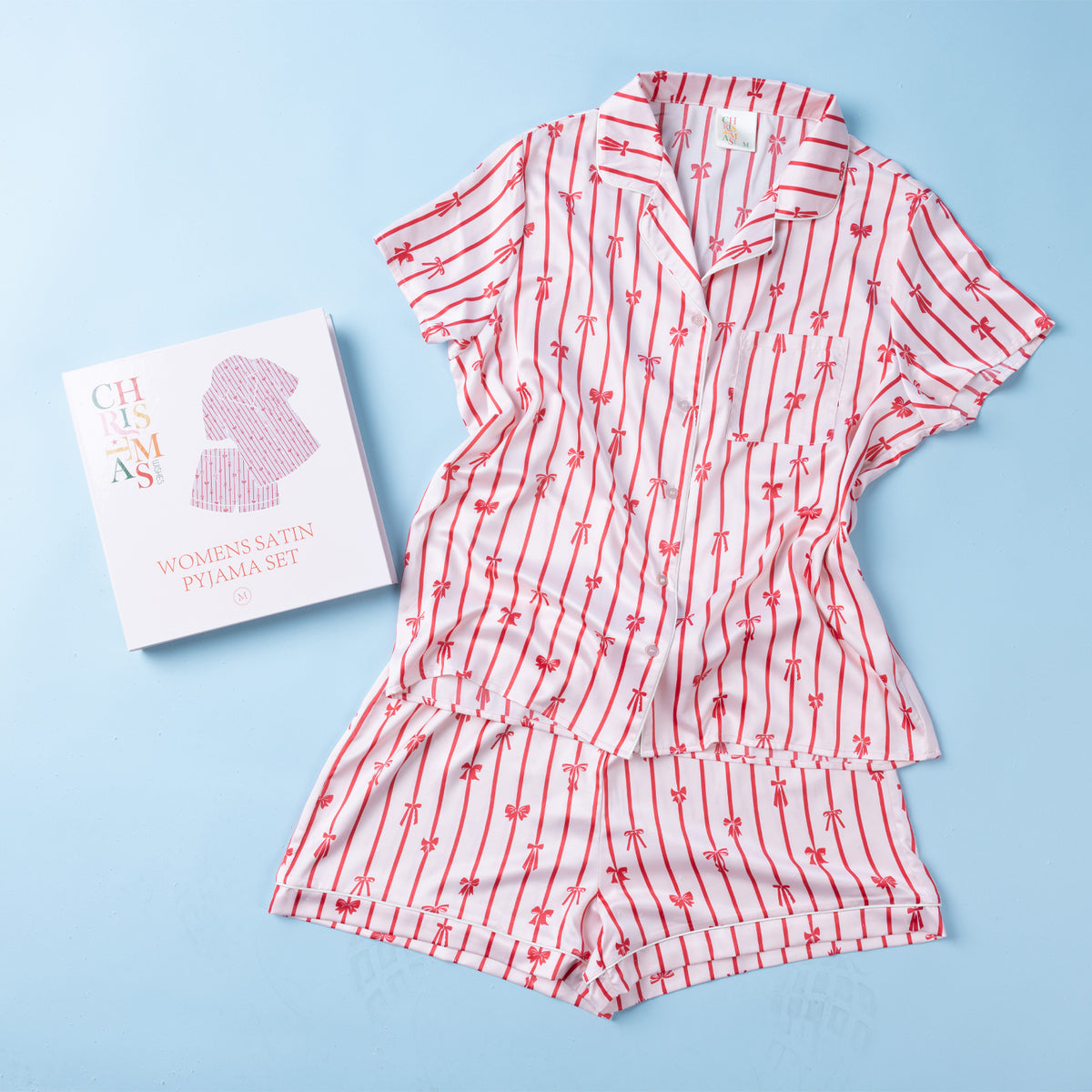 Christmas Wishes Women’s Satin Bow PJ Set displayed with matching gift box on a light blue background.