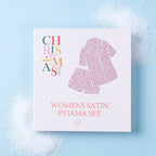 Christmas Wishes Women’s Satin Bow Pyjama Gift Set packaging displayed on a light blue background.